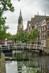 Fototapeta premium Picturesque Canal Bridge and Nieuwe Kerk Tower in Delft, Netherlands