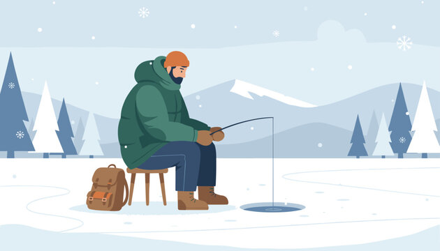 Patient man sitting on a stool while ice fishing on a frozen lake surrounded by snowy mountains and pine trees.