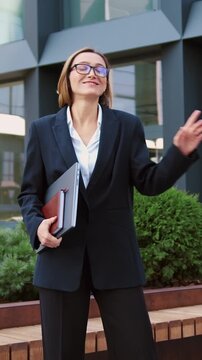 Attractive business woman performs freestyle street dance performance. Positive emotions, lucky contracts signed, project approved, successful lady. Office worker in suit has fun. Slow motion.
