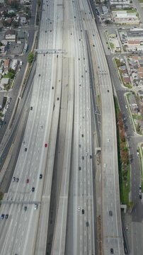 AERIAL: Slow Overhead Lookup over 110 Highway with little car traffic in Los Angeles, California on Cloudy Overcast Day 