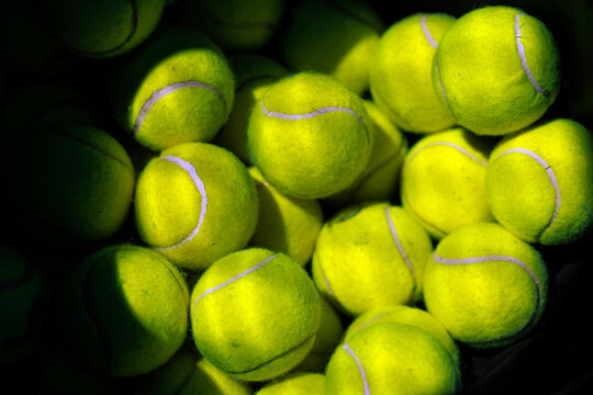 Full frame texture background of bright yellow tennis balls