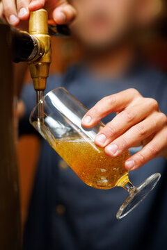 Close Up of Bartender Pouring Fresh Draft Beer into Glass