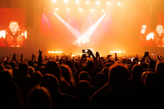 Concert Audience Cheering with Hands in Front of Stage