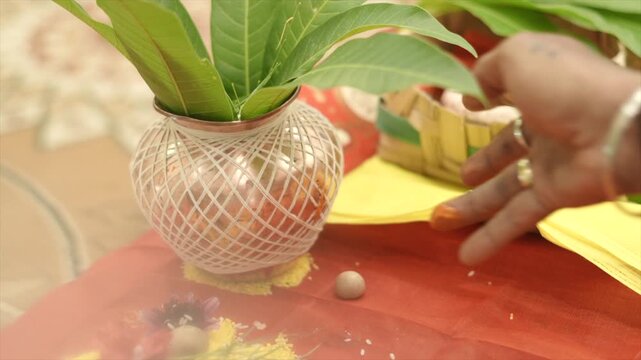 Auspicious Hindu wedding ceremony preparation featuring a sacred kalash, akshata rice, flowers, and traditional ritual items arranged for marriage rituals.