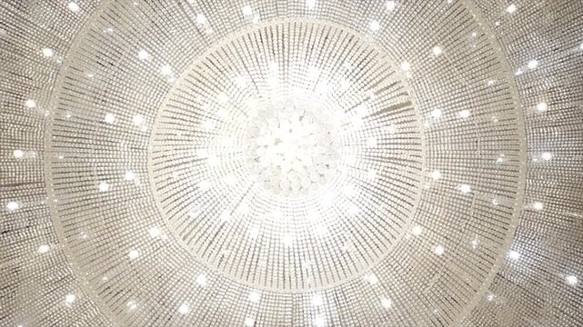 Elegant close-up view of a sparkling crystal chandelier hanging from the ceiling, reflecting brilliant light and adding luxury, sophistication, and timeless beauty to the interior.