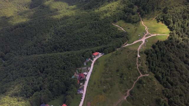 Rolling hills and dense forests filling a mountain landscape under a cloudy sky