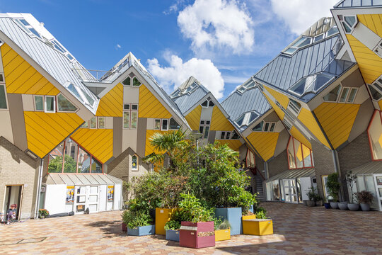 Rotterdam, Netherlands, 10 June 2026. Central courtyard underneath the futuristic yellow Cube Houses with green plants and unique geometric structures.