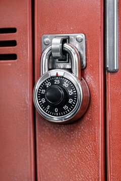 A close-up shot of a combination lock on a red suitcase, perfect for illustrating security, travel, or adventure concepts