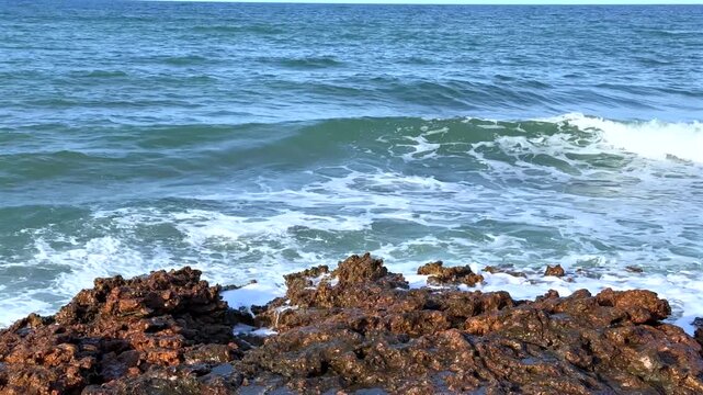 Waves Crashing on Dark Rocky Shore with Sea Spray