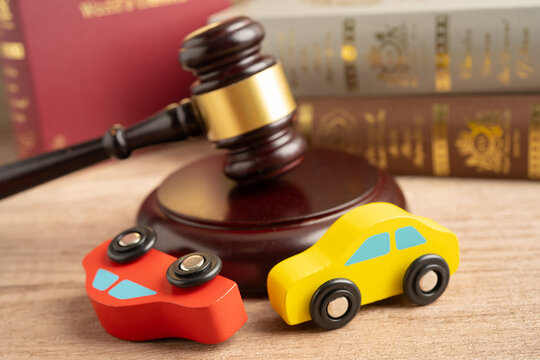 Car accident lawsuit and insurance, Judge hammer with car model.