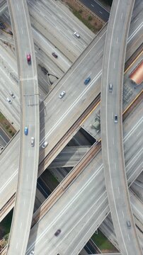 AERIAL: Spectacular Overhead Shot Rising up over Judge Pregerson Interchange showing multiple Roads, Bridges, Highway with little car traffic in Los Angeles, California on Beautiful Sunny Day