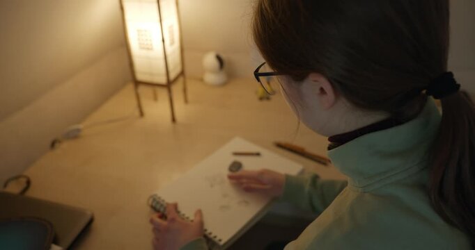 Girl Draw Pictures With Pencil on Desk Table in Bedroom at Home. 4K 10-bit