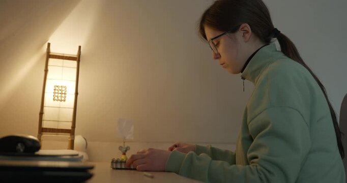 Girl Draw Pictures With Pencil on Desk Table in Bedroom at Home. 4K 10-bit