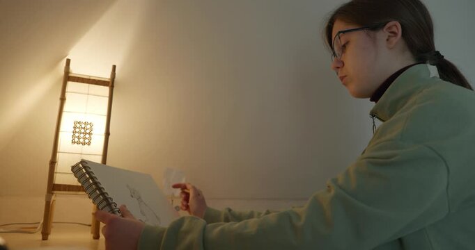 Girl Draw Pictures With Pencil on Desk Table in Bedroom at Home. 4K 10-bit