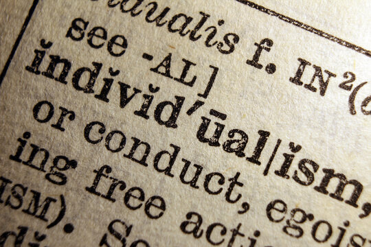 Word individualism on dictionary page, macro close up