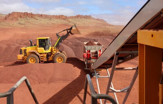 Medium sized hematite iron ore mining in the Pilbara, Mid West, the Yilgarn or Goldfields, and the Kimberley of Western Australia, and Northern Territory. Front end loader loading crushed ore