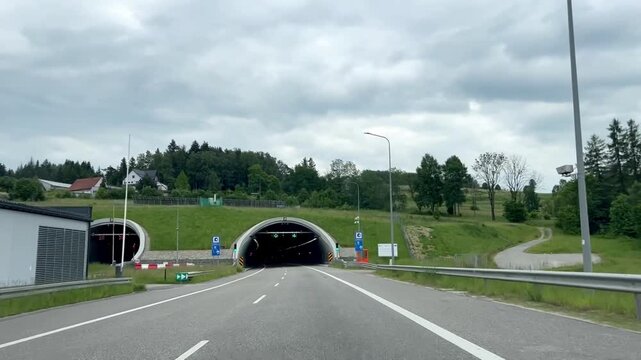 Car POV driving towards the Zakopianka highway tunnel S7 in Poland