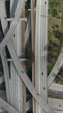 AERIAL: Spectacular Overhead follow Shot of Judge Pregerson Interchange showing multiple Roads, Bridges, Highway with little car traffic in Los Angeles, California on Beautiful Sunny Day
