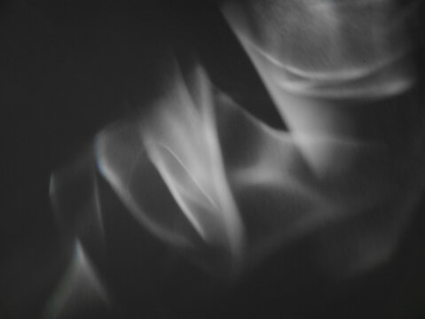 Shining caustics in gentle motion. Abstract caustic light patterns created by refraction and reflection on a transparent surface. Can be used as overlay elements for design projects. 