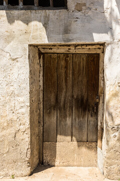 Old Ochre textured wall with old door
