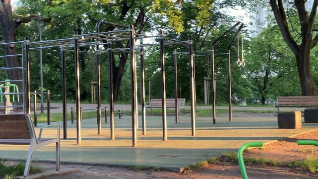 Big empty outdoor sports ground in morning light in city park in summer. Place for doing sports in the big city, activity, green space organization, wellness and healthcare