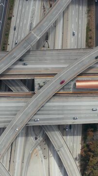 AERIAL: Spectacular Overhead follow Shot of Judge Pregerson Interchange showing multiple Roads, Bridges, Highway with little car traffic in Los Angeles, California on Beautiful Sunny Day