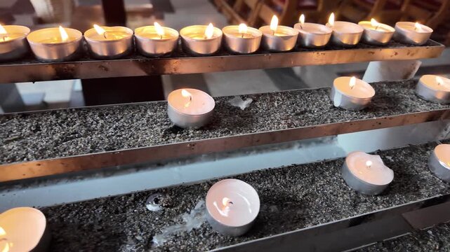 Cinematic Slow Motion View Of Rows Of Glowing Candles In A Church