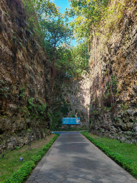 Paved Pathway Through Limestone Cliff Gorge at GWK Cultural Park Bali