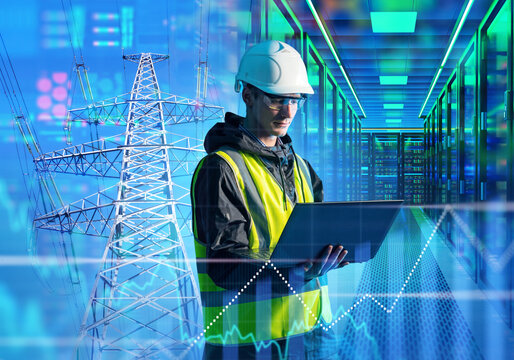 Energy data center. Electrical engineer monitors power grid supply and server infrastructure using laptop in digital control facility