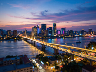 Obraz premium City skyline with river bridge at dusk night view