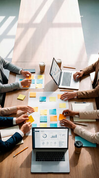 Top view of business team planning project with laptops and colorful sticky notes