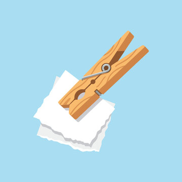A wooden clothespin holds small white paper scraps