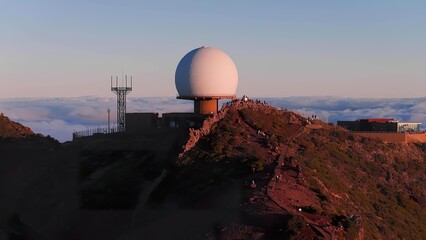 Large radar dome on mountain peak with antennas and buildings © Iremia