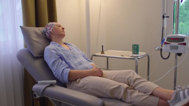 Woman undergoing chemotherapy treatment while resting in medical infusion chair, healthcare recovery scene highlighting resilience, cancer care, healing and patient wellbeing