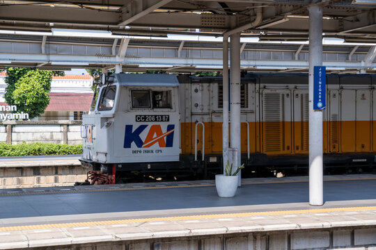 Jakarta, Indonesia - May 28, 2026: A close-up of a KAI CC206 diesel-electric locomotive hauling a long-distance passenger train through Jatinegara Station.