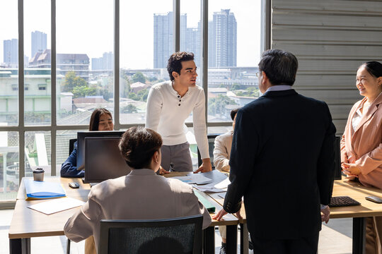 Team of young caucasian entrepreneur having a team meeting for project for marketing and sale management with skyscraper view for business startup and education