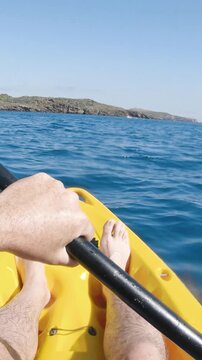 First person view kayaking in the mediterranean sea on a sunny summer day. Concept about summer, lifestyle,wanderlust travel and nature - vertical video for story and reels