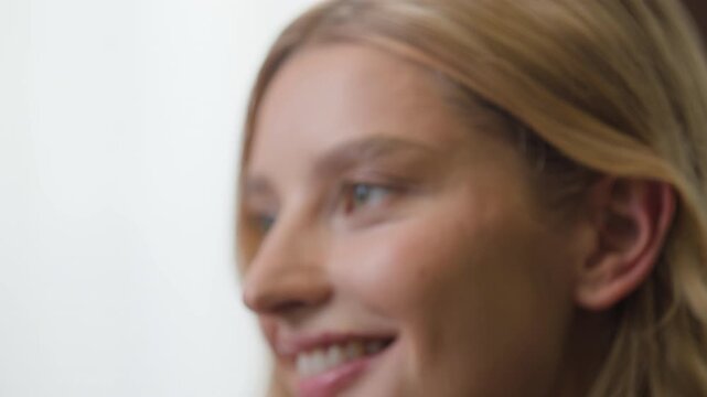 Close up charming Caucasian woman touching sensitive face skin cosmetic thinking dreaming smile indoors. Headshot beautiful joyous inspired female girl wife girlfriend looking at camera smiling dream