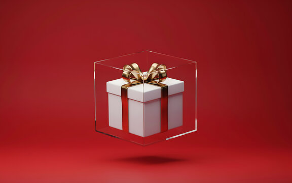 Gift box with gold ribbon encased in a transparent acrylic cube against a red background present
