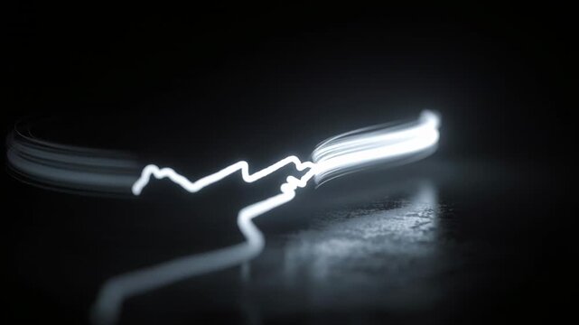 Starting motor white light trail looping then scribbling across dark surface creating art