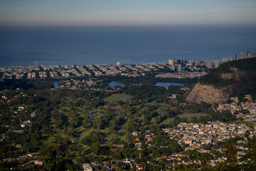 Obraz premium High angle panoramic view of Rio de Janeiro, a coastal city, with a large green golf course nestled between urban neighborhoods and the ocean horizon