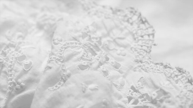 Handmade embroidered lace close-up, rotating background, top view