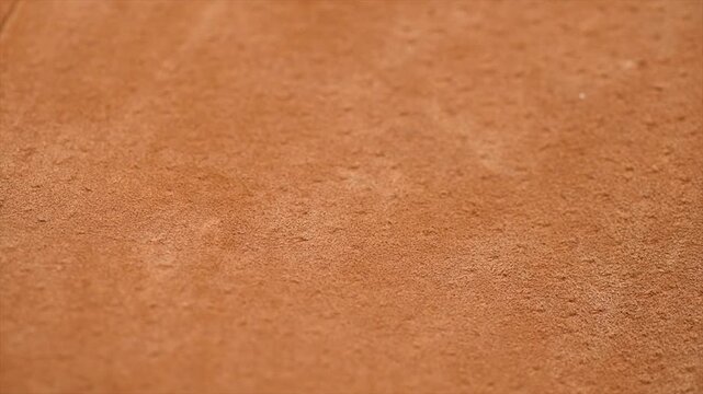 Brown suede texture background close up. Suede leather surface backdrop, genuine leather, top view. Suede of animal skin. Texture for design. Rotating background