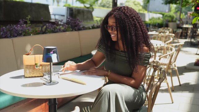 A young woman sitting in a cafe and reading a book