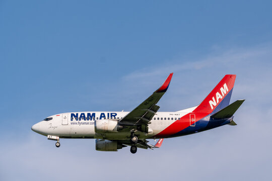 Jakarta, Indonesia - May 28, 2026: A NAM Air Boeing 737 preparing to land at Soekarno-Hatta International Airport under a clear blue sky.
