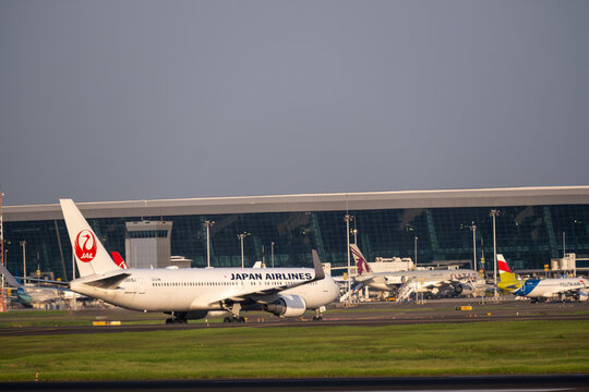 Jakarta, Indonesia - May 28, 2026: A Japan Airlines Boeing 767 taxiing at Soekarno-Hatta International Airport, with airport terminal buildings in the background.
