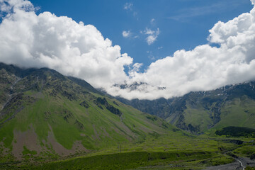 Fototapeta premium A picturesque mountain landscape in the Kazbegi region of Georgia. This region is famous for its high peaks, alpine meadows, and popular hiking trails.