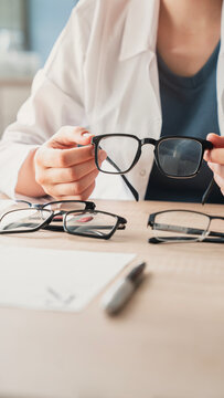 Ophthalmologist offers glasses to patient