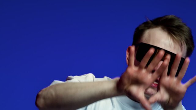 Expressive man gesture with oversized visor glasses