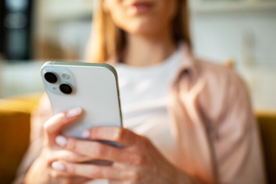 Close-up of woman using smartphone at home